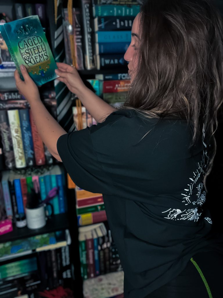 female reaching for book on bookshelf